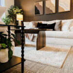 Therapyworthwhile modern counseling office with a beige sofa and dark accent wall.