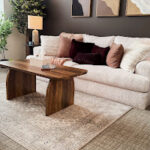 Therapyworthwhile modern counseling office with a beige sofa and dark accent wall.